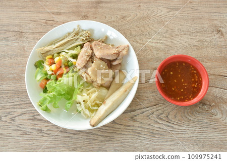Korean fried slice pork with salad on plate dipping spicy sauce 109975241