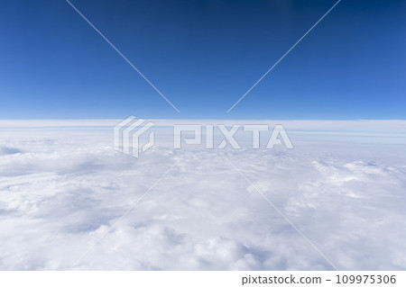 Blue sky and sea of clouds seen from the airplane window 109975306