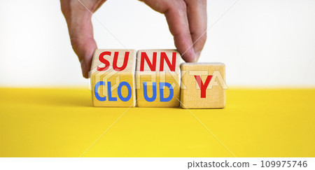 Sunny or cloudy symbol. Concept word Sunny or Cloudy on wooden cubes. Beautiful yellow table white background. Businessman hand. Business lifestyle and sunny or cloudy concept. Copy space. 109975746