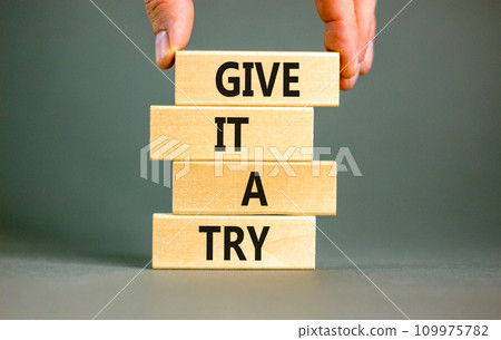 Give it a try symbol. Concept word Give it a try on beautiful wooden block. Beautiful grey table grey background. Businessman hand. Business give it a try concept. Copy space. Give it a try symbol. Concept word Give it a try on beautiful wooden block. Beautiful grey table grey background. Businessman hand. Business give it a try concept. Copy space. 109975782