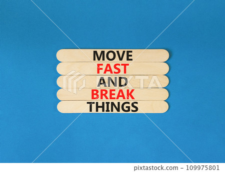 Move fast and break things symbol. Concept words Move fast and break things on wooden stick. Beautiful blue table blue background. Business, move fast and break things concept. Copy space. 109975801