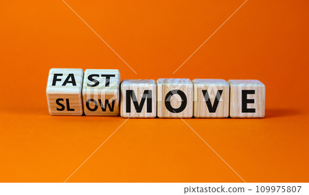 Time to fast move symbol. Turned wooden cubes and changed words 'slow move' to 'fast move'. Beautiful orange table, orange background, copy space. Business and slow or fast move concept. Time to fast move symbol. Turned wooden cubes and changed words 'slow move' to 'fast move'. Beautiful orange table, orange background, copy space. Business and slow or fast move concept. 109975807