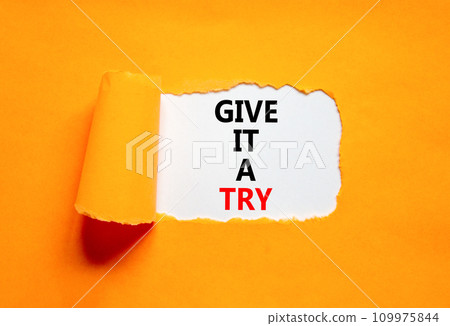 Give it a try symbol. Concept word Give it a try on beautiful white paper. Beautiful orange paper background. Business give it a try concept. Copy space. 109975844