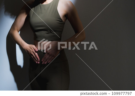 A woman wearing training wear 109977797