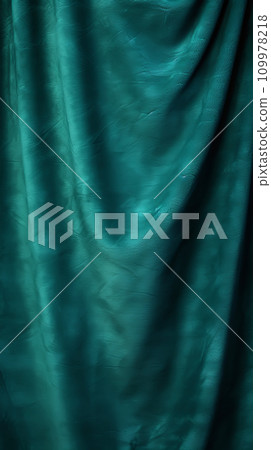 Elegant velvet fabric background. Emerald green velor flows in waves and folds, vertical format Elegant velvet fabric background. Emerald green velor flows in waves and folds, vertical format 109978218