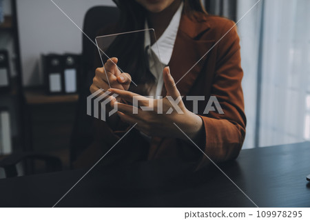 Asian Businesswoman Using laptop computer and working at office with calculator document on desk, doing planning analyzing the financial report, business plan investment, finance analysis concept. Asian Businesswoman Using laptop computer and working at office with calculator document on desk, doing planning analyzing the financial report, business plan investment, finance analysis concept. 109978295