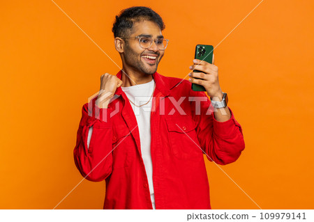 Happy excited winner man use smartphone celebrating success, winning play game, good lottery news 109979141