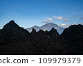 Landscape view of Mount Abang in the background through solidified black volcanic lava of an active volcano Batur, Bali island. 109979379