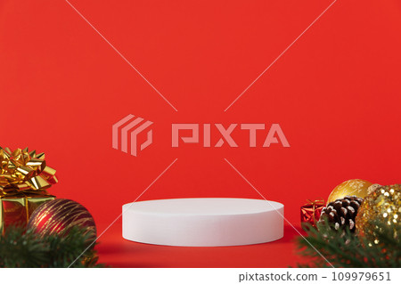 White podium and christmas decorations on red background. White podium and christmas decorations on red background. 109979651