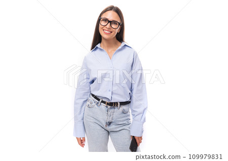 young pretty european business woman with long black hair dressed in a blue blouse and glasses on a young pretty european business woman with long black hair dressed in a blue blouse and glasses on a 109979831