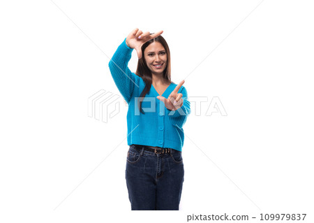 positive young brunette woman dressed in a blue cardigan with buttons 109979837