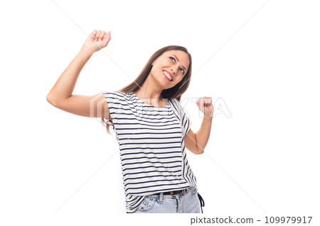 young cheerful energetic caucasian brunette woman in a striped t-shirt smiling on a white background young cheerful energetic caucasian brunette woman in a striped t-shirt smiling on a white background 109979917