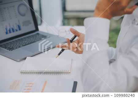 Business people meeting at office writing notes about sticky notes Laptop,tablet Planning and Brainstorming Strategies of Colleagues in office 109980240