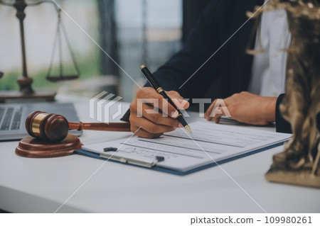 Business and lawyers discussing contract papers with brass scale on desk in office. Law, legal services, advice, justice and law concept picture with film grain effect Business and lawyers discussing contract papers with brass scale on desk in office. Law, legal services, advice, justice and law concept picture with film grain effect 109980261