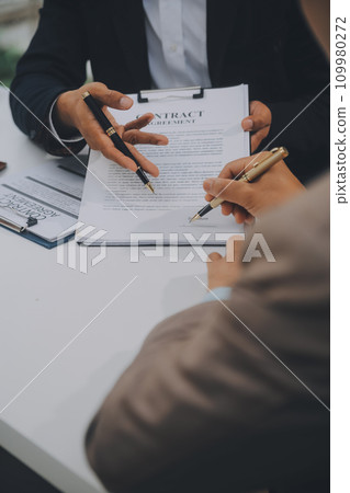 Business and lawyers discussing contract papers with brass scale on desk in office. Law, legal services, advice, justice and law concept picture with film grain effect Business and lawyers discussing contract papers with brass scale on desk in office. Law, legal services, advice, justice and law concept picture with film grain effect 109980272