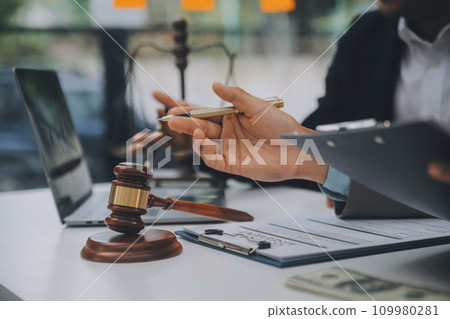 Business and lawyers discussing contract papers with brass scale on desk in office. Law, legal services, advice, justice and law concept picture with film grain effect 109980281