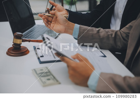 Business and lawyers discussing contract papers with brass scale on desk in office. Law, legal services, advice, justice and law concept picture with film grain effect 109980283