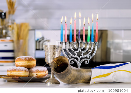 Candle light during Hanukkah celebrations Hanukkiah Menorah Jewish religion holiday symbol Candle light during Hanukkah celebrations Hanukkiah Menorah Jewish religion holiday symbol 109981004