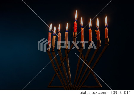 Hanukkiah Menorah with candles burning is traditional symbol of Jewish faith during holiday Hanukkah Hanukkiah Menorah with candles burning is traditional symbol of Jewish faith during holiday Hanukkah 109981015