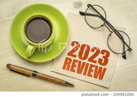 2023 year review text on a napkin with a cup of coffee, end of year business concept 109981086