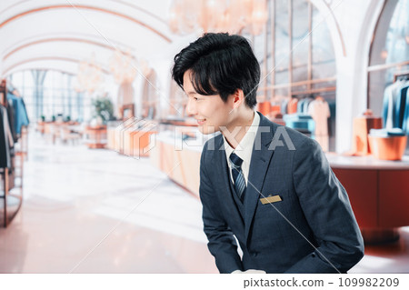 Male staff serving customers at a luxury brand store Male staff serving customers at a luxury brand store 109982209