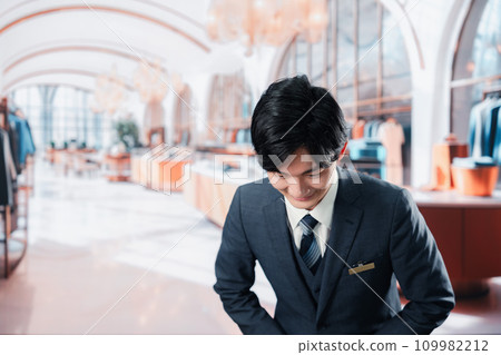 Male staff serving customers at a luxury brand store Male staff serving customers at a luxury brand store 109982212