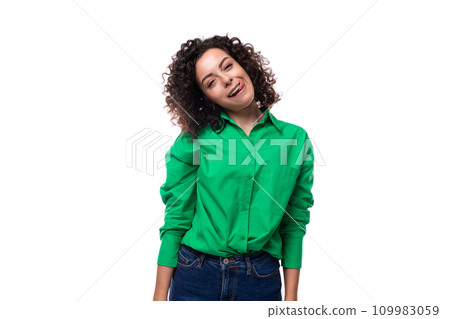 portrait of a 30 year old stylish caucasian brunette woman with a curled hair dressed in a green 109983059