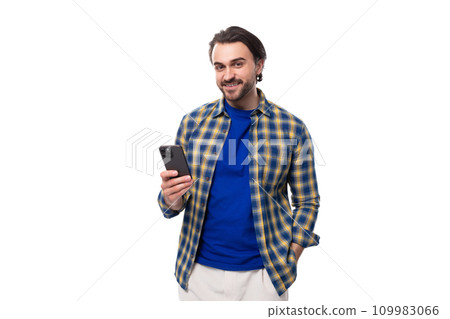 young caucasian brunette man with a beard and an earring is dressed in a blue plaid shirt and t young caucasian brunette man with a beard and an earring is dressed in a blue plaid shirt and t 109983066