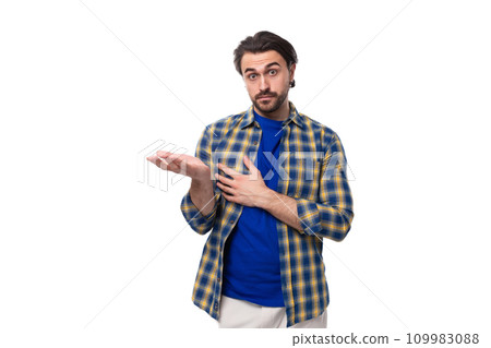 young caucasian brunette man with a beard and an earring is dressed in a blue plaid shirt and t young caucasian brunette man with a beard and an earring is dressed in a blue plaid shirt and t 109983088