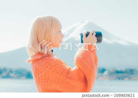 Young woman photographing Mt. Fuji Young woman photographing Mt. Fuji 109983621