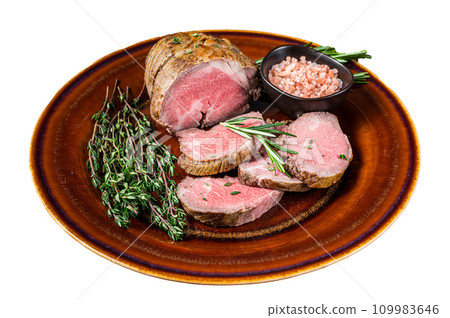 Grilled Roast beef fillet meat on a rustic plate with salt. Isolated on white background, top view. Grilled Roast beef fillet meat on a rustic plate with salt. Isolated on white background, top view. 109983646