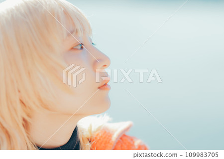 Portrait of a woman looking at a winter lake Portrait of a woman looking at a winter lake 109983705