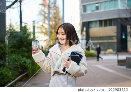 A woman walking in the city 109983813