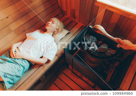 Woman entering the sauna Woman entering the sauna 109984960