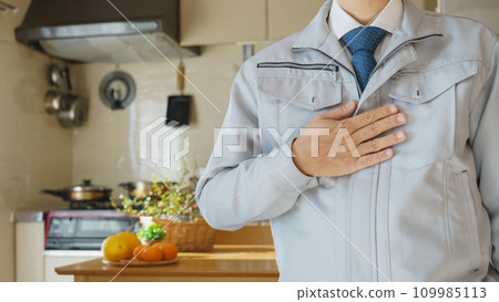 A man in work clothes inspects the kitchen and dining room | Renovation survey and estimate image A man in work clothes inspects the kitchen and dining room | Renovation survey and estimate image 109985113