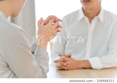 Asian couple having a serious talk Asian couple having a serious talk 109988151