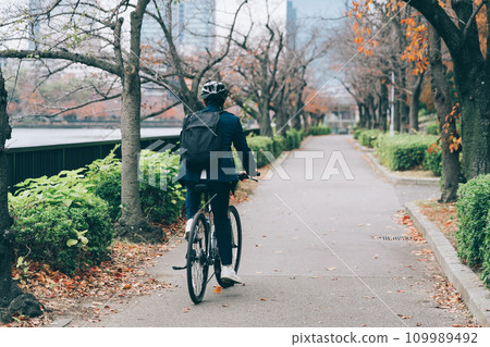A businessman riding a bicycle A businessman riding a bicycle 109989492