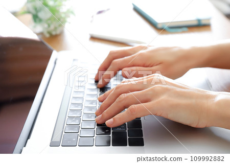 hands working with a computer 109992882