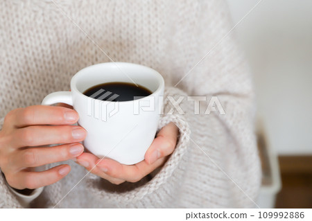 Hand holding coffee - winter image 109992886