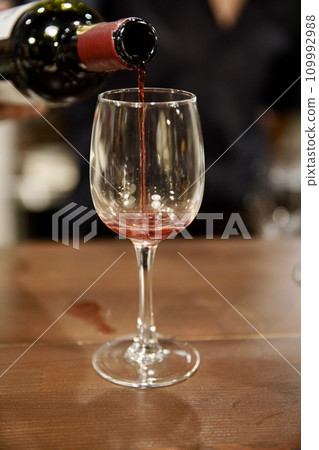 wine being poured into a wine glass wine being poured into a wine glass 109992988