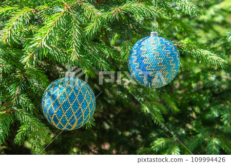 Exquisite handmade Christmas bubble toy from beads, also known as a Christmas globe or Christmas bulb, is a part of holiday decor 109994426