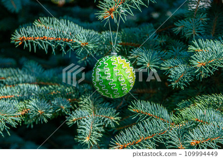 Exquisite handmade Christmas bubble toy from beads, also known as a Christmas globe or Christmas bulb, is a part of holiday decor Exquisite handmade Christmas bubble toy from beads, also known as a Christmas globe or Christmas bulb, is a part of holiday decor 109994449