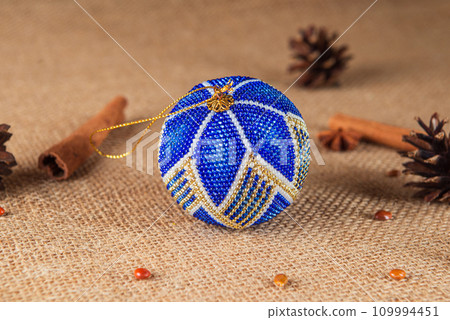 Exquisite handmade Christmas bubble toy from beads, also known as a Christmas globe or Christmas bulb, is a part of holiday decor Exquisite handmade Christmas bubble toy from beads, also known as a Christmas globe or Christmas bulb, is a part of holiday decor 109994451