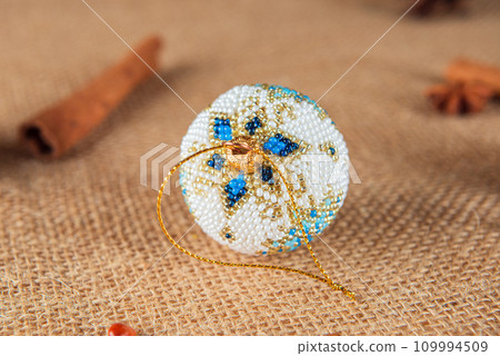 Exquisite handmade Christmas bubble toy from beads, also known as a Christmas globe or Christmas bulb, is a part of holiday decor Exquisite handmade Christmas bubble toy from beads, also known as a Christmas globe or Christmas bulb, is a part of holiday decor 109994509