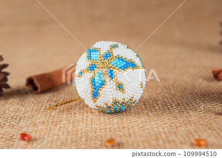 Exquisite handmade Christmas bubble toy from beads, also known as a Christmas globe or Christmas bulb, is a part of holiday decor Exquisite handmade Christmas bubble toy from beads, also known as a Christmas globe or Christmas bulb, is a part of holiday decor 109994510