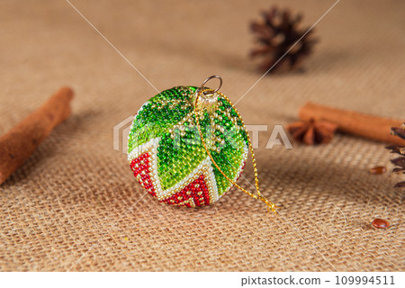 Exquisite handmade Christmas bubble toy from beads, also known as a Christmas globe or Christmas bulb, is a part of holiday decor Exquisite handmade Christmas bubble toy from beads, also known as a Christmas globe or Christmas bulb, is a part of holiday decor 109994511