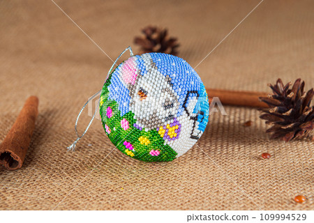 Exquisite handmade Christmas bubble toy from beads, also known as a Christmas globe or Christmas bulb, is a part of holiday decor Exquisite handmade Christmas bubble toy from beads, also known as a Christmas globe or Christmas bulb, is a part of holiday decor 109994529