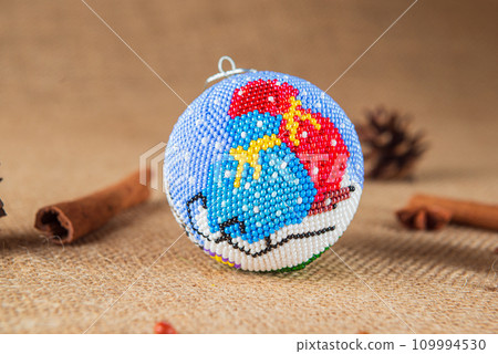 Exquisite handmade Christmas bubble toy from beads, also known as a Christmas globe or Christmas bulb, is a part of holiday decor 109994530