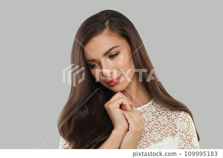 Pretty young brunette model woman with long healthy hair, clear fresh skin and makeup  109995183