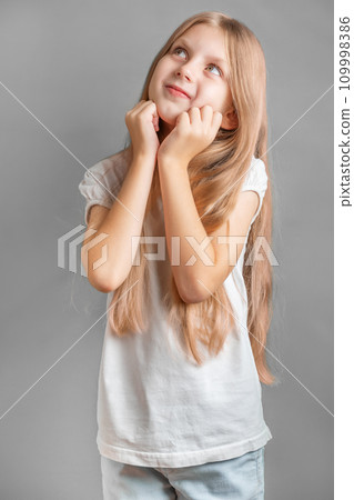 Portrait of positive cheerful girl cutely smiling Portrait of positive cheerful girl cutely smiling 109998386